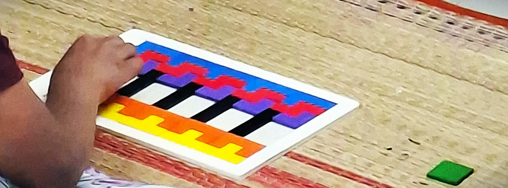 Child playing with a colorful learning puzzle game at home