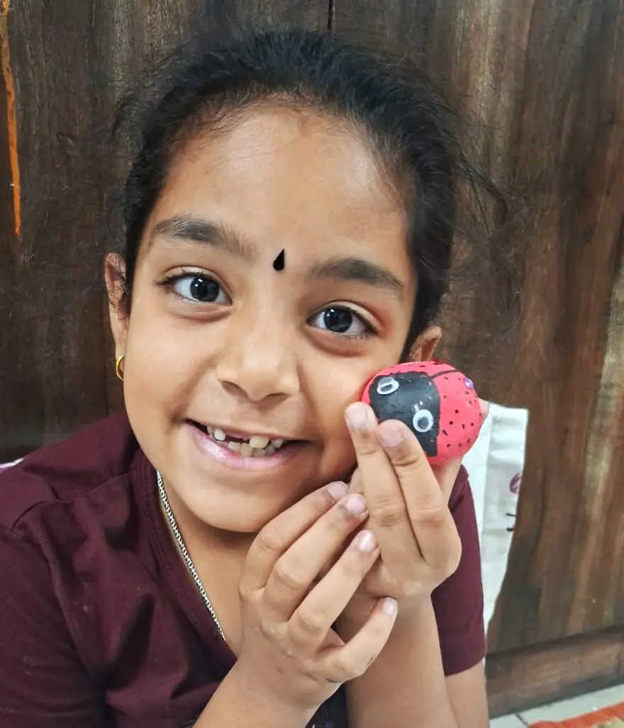 Kid being creative while playing with rocks