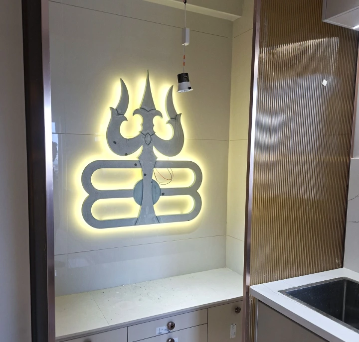 New home interior with illuminated Om wall décor and modern kitchen New home interior with illuminated Om wall décor and modern kitchen