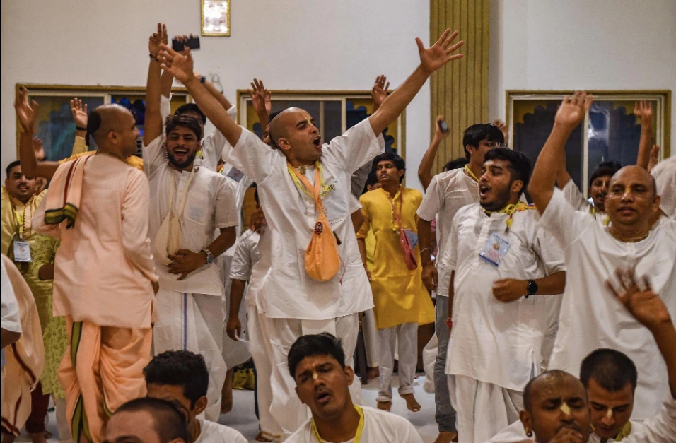ISKCON devotees singing and dancing together during a devotional celebration