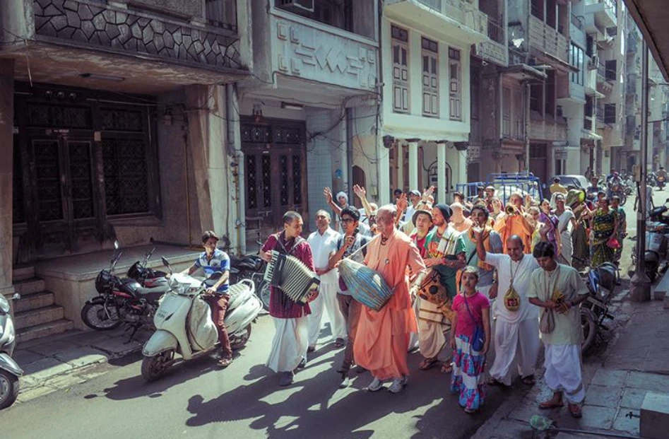 ISKCON devotees singing and dancing in a devotional street kirtan