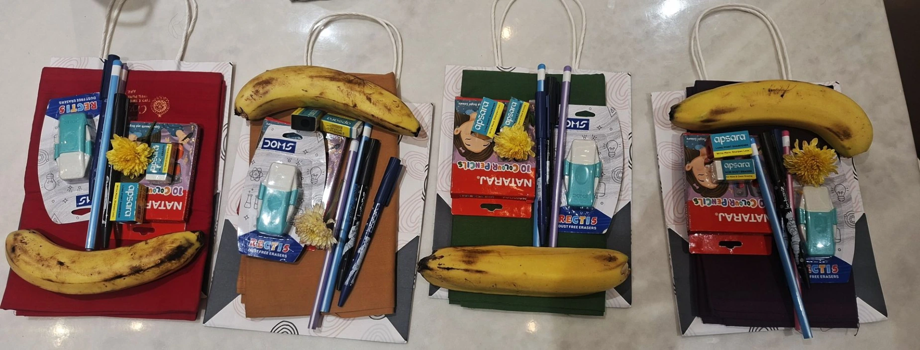 Gift bags containing stationery, bananas, and flowers prepared for little girls during Vijayadashami. Tamboolam Gifts for Little Girls